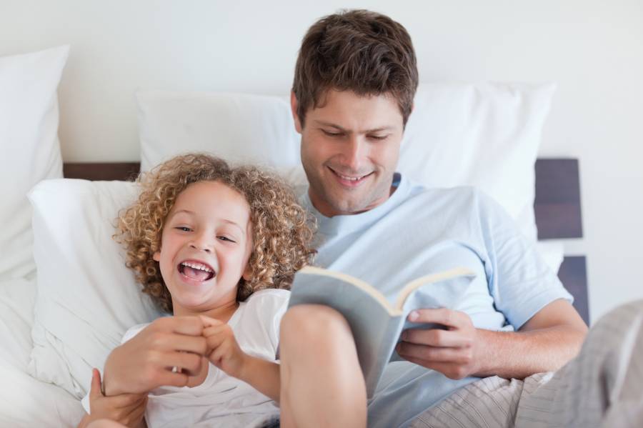 Father reading bedtime story for his child