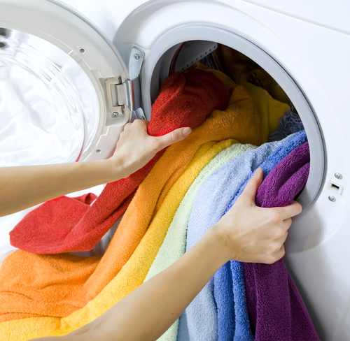 Women removing towels from dryer